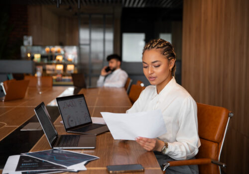 A lady reviewing documents in an office setting.