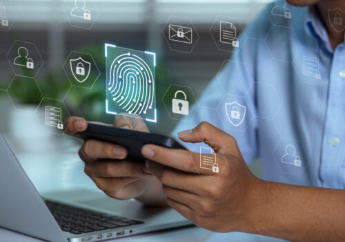 Hands holding a smartphone with digital lock and verification icons representing an age verification system